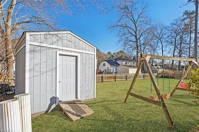 view of outbuilding featuring a yard and a playground