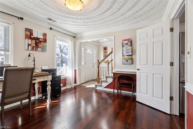 foyer entrance with crown molding, a healthy amount of sunlight, and dark hardwood / wood-style flooring