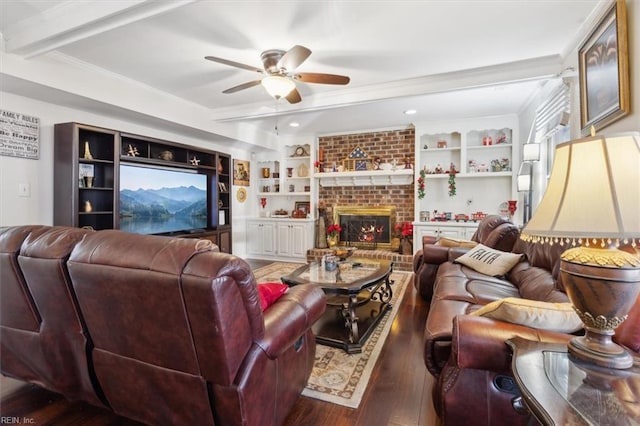 living room with dark hardwood / wood-style floors, built in features, a fireplace, ceiling fan, and crown molding