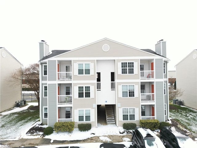 snow covered property featuring central AC