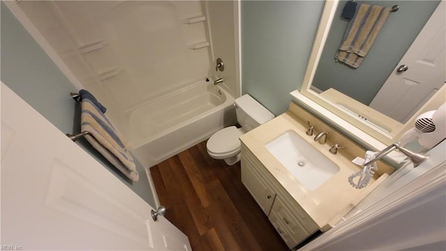 full bathroom featuring washtub / shower combination, wood-type flooring, toilet, and vanity