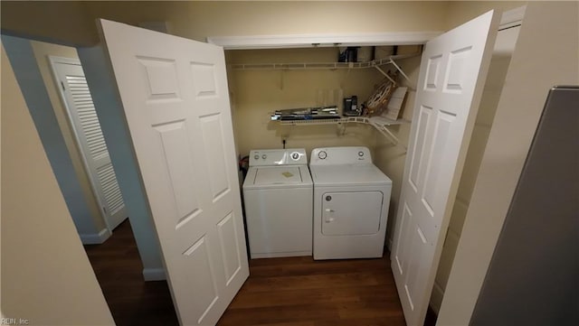 washroom with separate washer and dryer and dark hardwood / wood-style floors