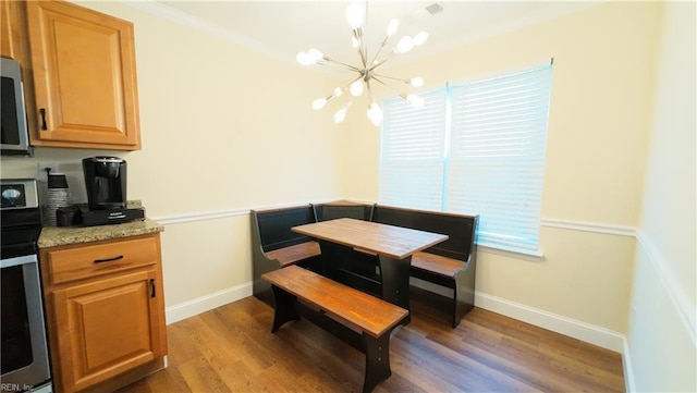 dining space with a notable chandelier and dark hardwood / wood-style flooring