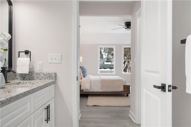 bedroom featuring sink and light hardwood / wood-style flooring