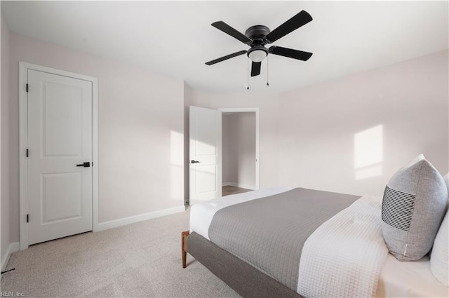 bedroom featuring light colored carpet and ceiling fan