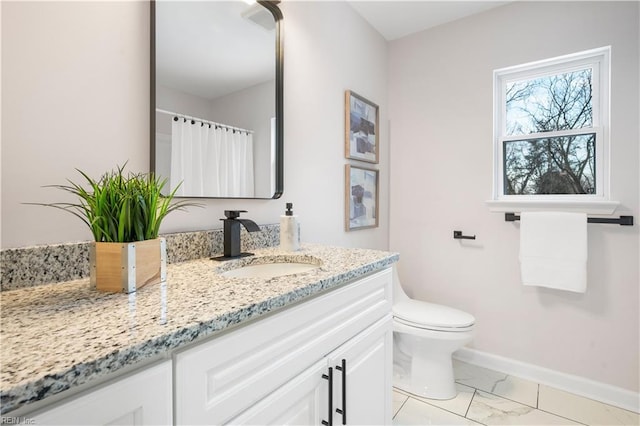 bathroom featuring vanity and toilet