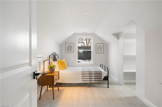 carpeted bedroom with vaulted ceiling