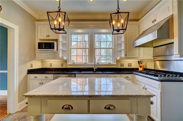 kitchen featuring dark stone counters, a kitchen island, and white cabinets