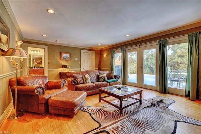 living room with french doors, light hardwood / wood-style floors, and a wealth of natural light