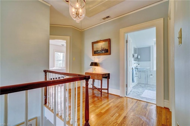 hallway with crown molding and wood-type flooring