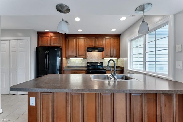 kitchen featuring sink, tasteful backsplash, light tile patterned floors, pendant lighting, and black appliances