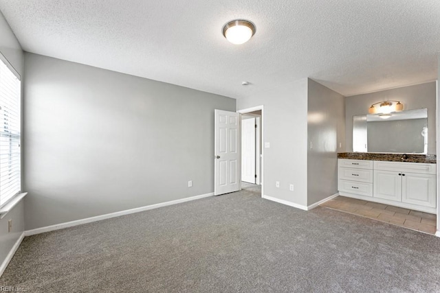 unfurnished bedroom featuring carpet and a textured ceiling