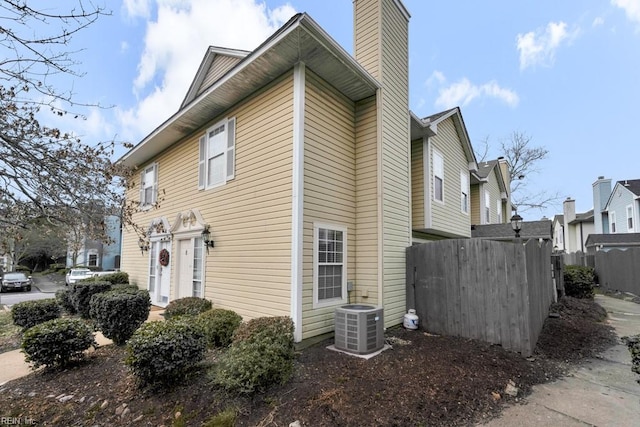 view of side of home featuring central AC unit