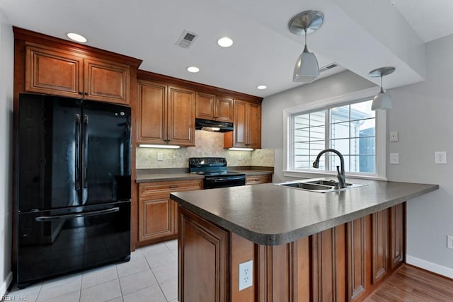 kitchen featuring decorative light fixtures, black appliances, sink, backsplash, and kitchen peninsula