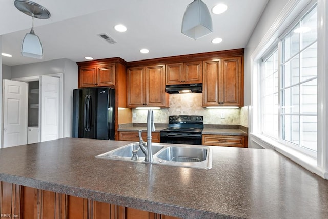 kitchen with pendant lighting, sink, tasteful backsplash, and black appliances