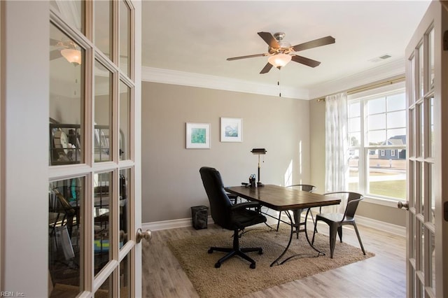 home office featuring crown molding, ceiling fan, light hardwood / wood-style floors, and french doors