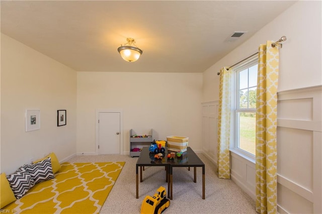 recreation room featuring light colored carpet