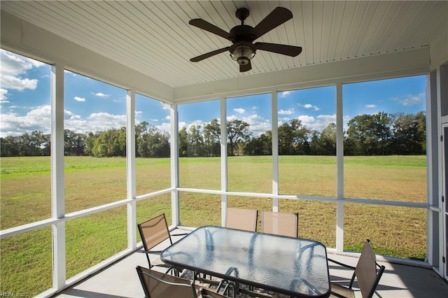 unfurnished sunroom with ceiling fan