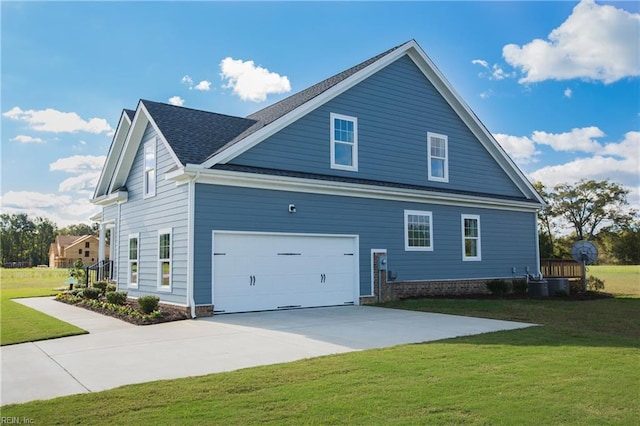 view of side of property featuring a garage, a yard, and central air condition unit