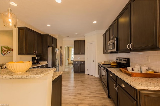 kitchen featuring decorative light fixtures, dark brown cabinets, appliances with stainless steel finishes, light stone countertops, and light hardwood / wood-style floors