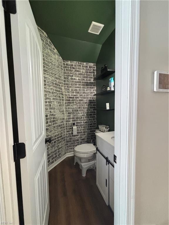 bathroom featuring hardwood / wood-style flooring, vanity, and toilet