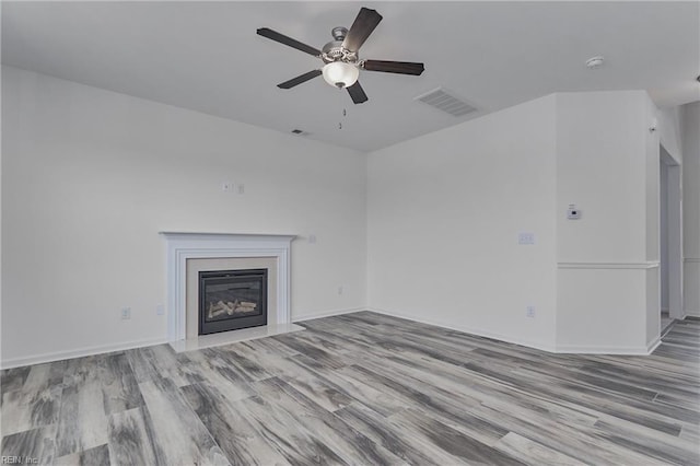 unfurnished living room with ceiling fan and light wood-type flooring