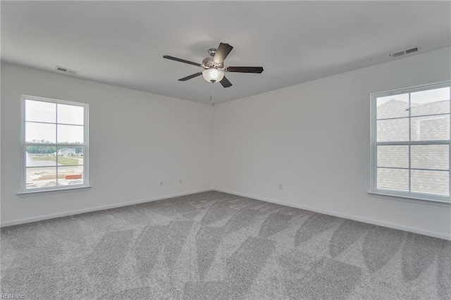 carpeted spare room with ceiling fan