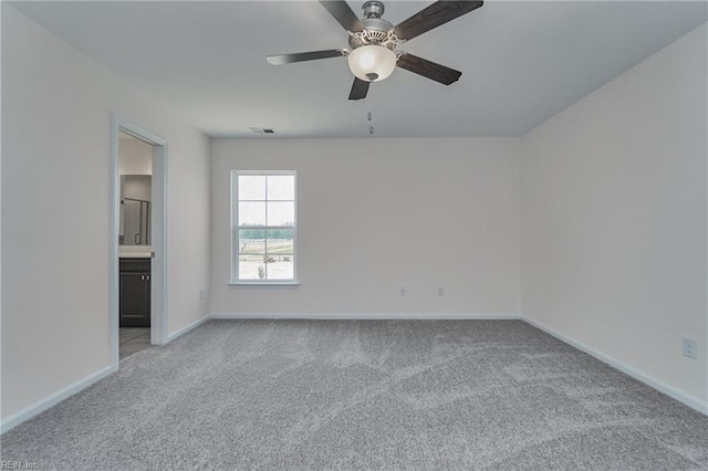 empty room with light colored carpet and ceiling fan