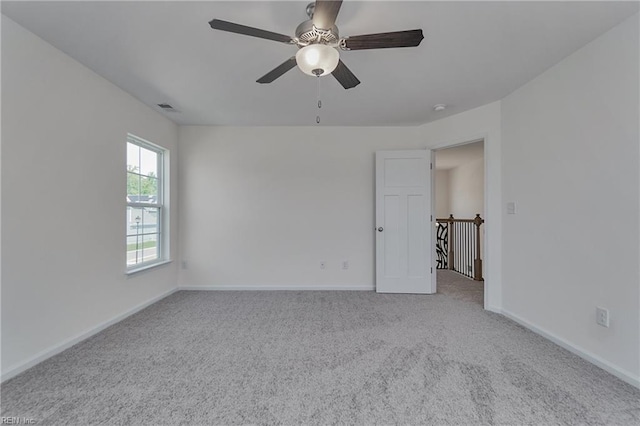 carpeted empty room featuring ceiling fan