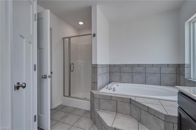 bathroom with vanity, tile patterned floors, and plus walk in shower