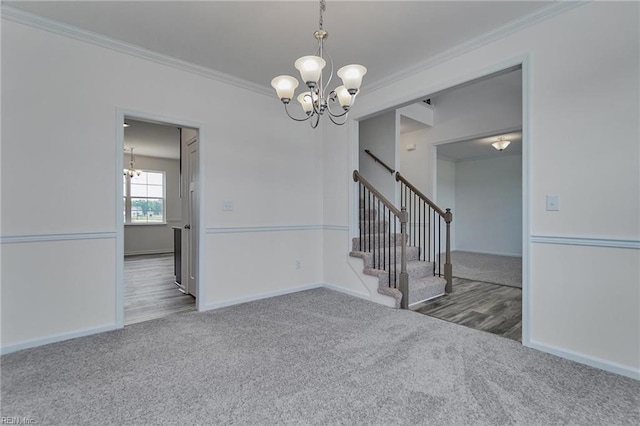 unfurnished room with ornamental molding, a chandelier, and dark colored carpet