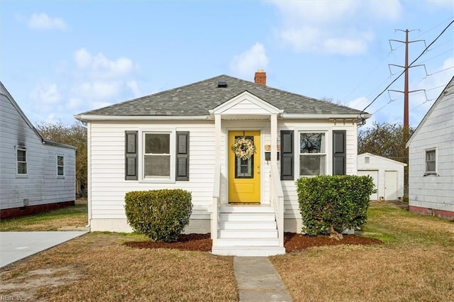 bungalow-style home featuring a front lawn