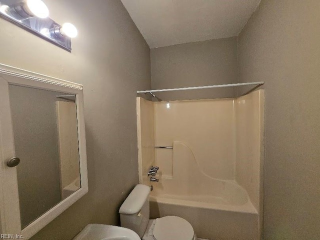 bathroom featuring shower / washtub combination and toilet