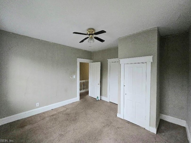 unfurnished bedroom featuring light colored carpet and ceiling fan