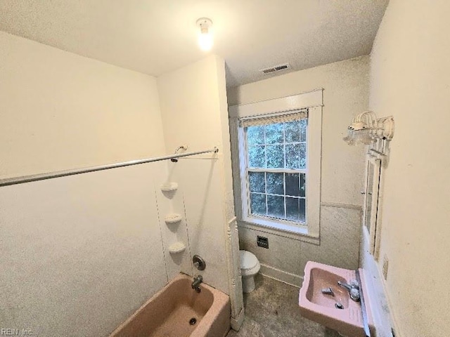 bathroom with toilet and washtub / shower combination