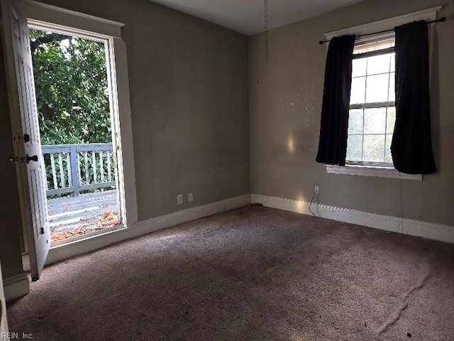 carpeted empty room with plenty of natural light