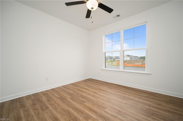 spare room with ceiling fan and hardwood / wood-style floors