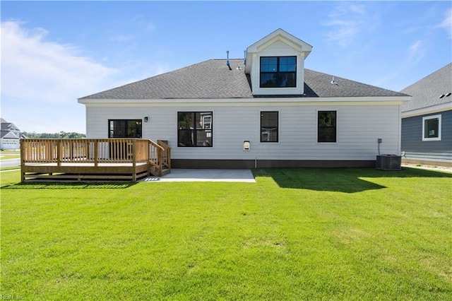 rear view of house with a patio, a deck, a lawn, and central air condition unit