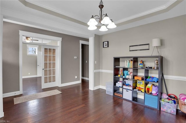 recreation room with french doors, a raised ceiling, and dark wood-type flooring