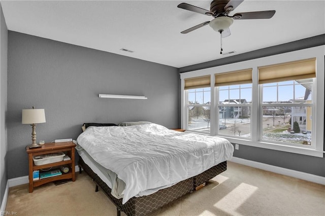 bedroom featuring light colored carpet and ceiling fan