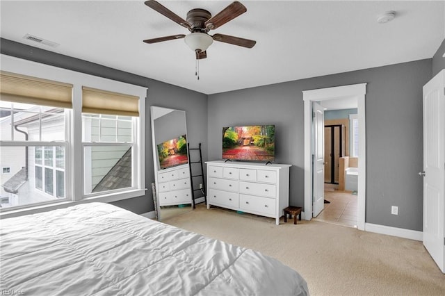 carpeted bedroom featuring ensuite bathroom and ceiling fan