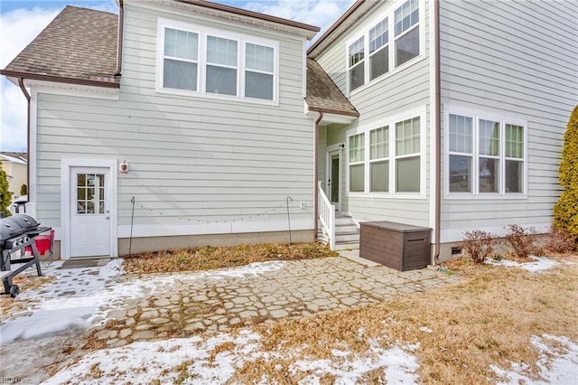 snow covered property with a patio area