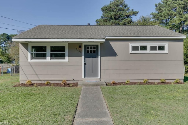 bungalow-style home featuring a front lawn