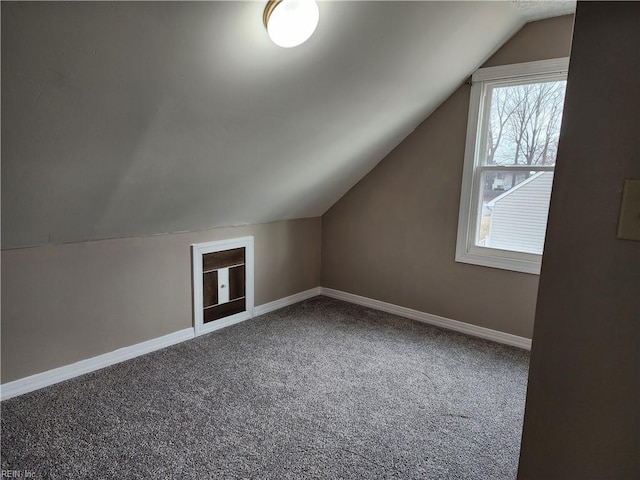 additional living space featuring lofted ceiling and carpet floors