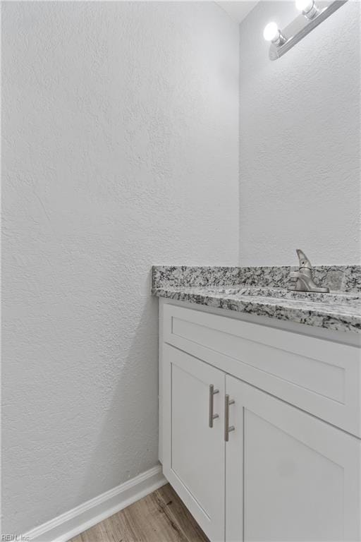 bathroom featuring vanity and hardwood / wood-style flooring