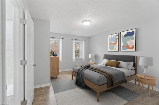 bedroom featuring wood-type flooring and a textured ceiling