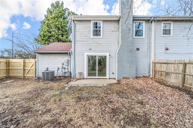 back of house featuring central AC