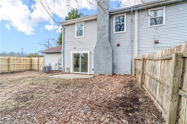 back of house with central AC unit and a patio