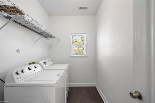 laundry area featuring dark hardwood / wood-style floors and washing machine and clothes dryer