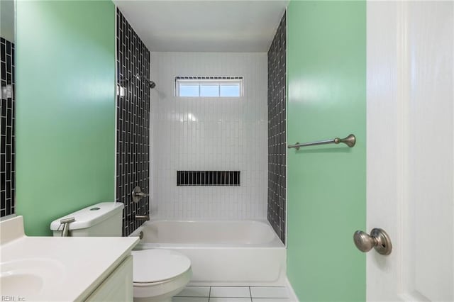 full bathroom with tiled shower / bath, tile patterned floors, toilet, and vanity